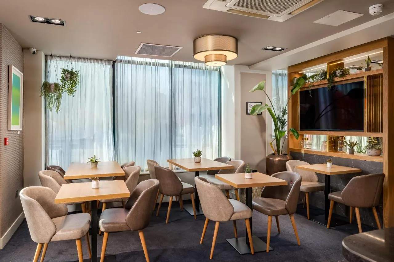 Restaurant seating area with tables and a television